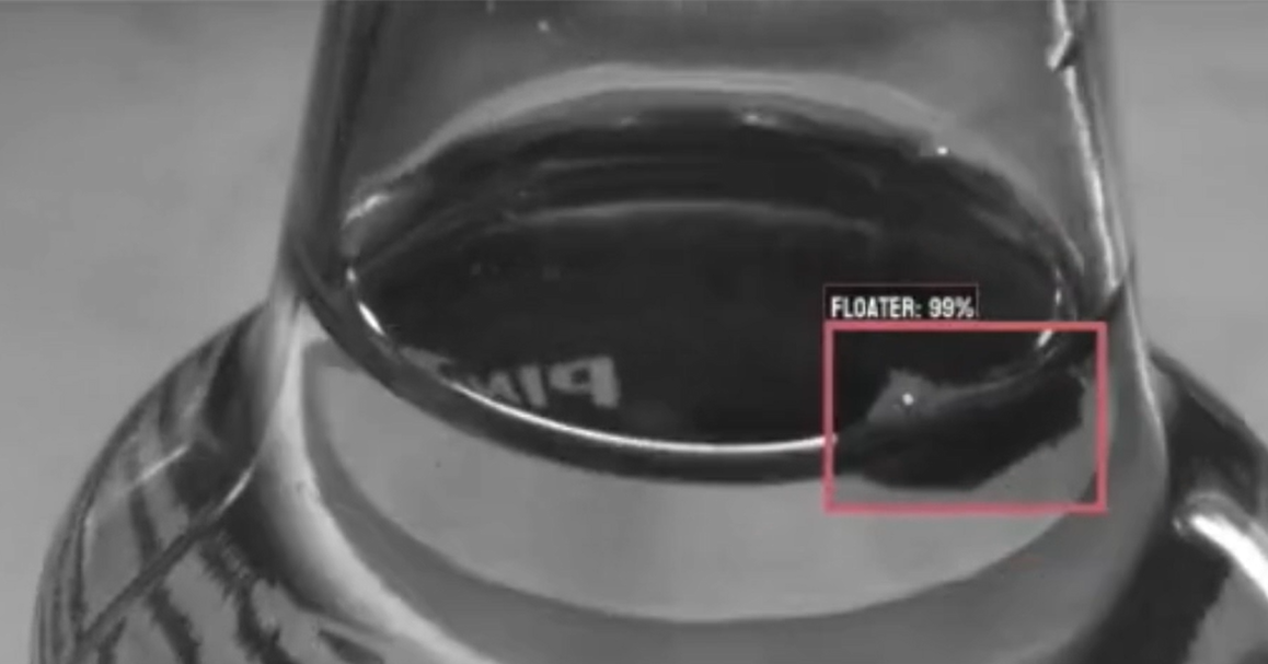 High-speed vision system detecting floating foreign material inside a filled glass bottle
