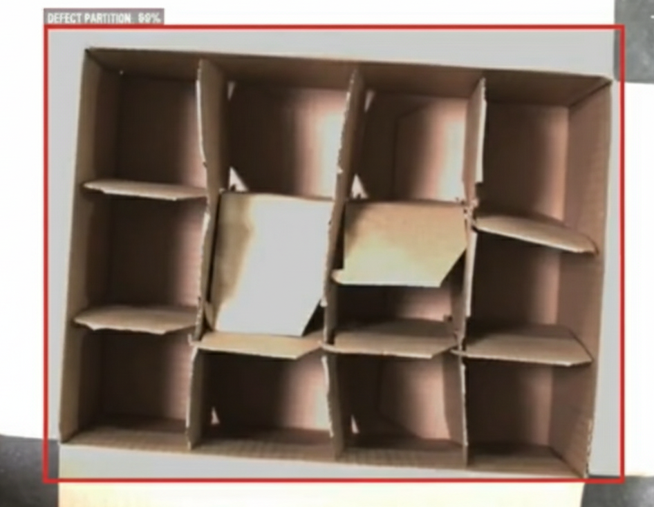 Vision system checking the integrity of corrugated cardboard case partitions inside a package